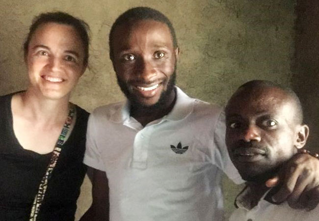Dieu-Merci (center) with his physical therapist (right) and Crossworld worker Mindy (left)